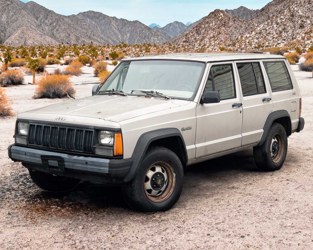 1995 Jeep Cherokee XJ white 4-door SUV – three-quarter front view in desert setting