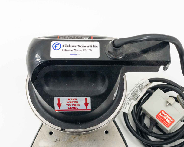 Fisher Scientific FS-100 label on motor housing showing brand name and model, with water level indicator sticker