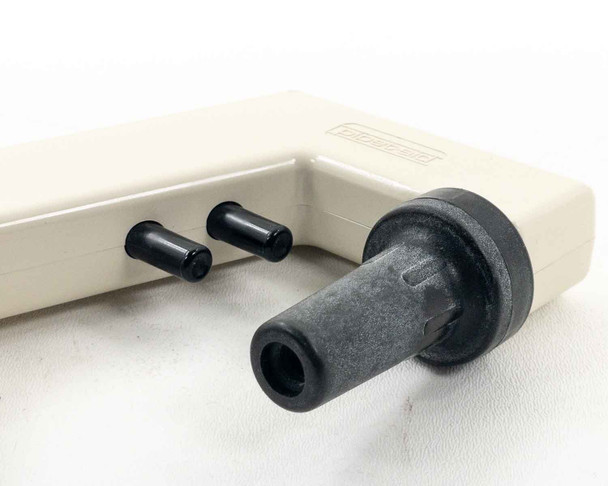 Drummond Pipet-Aid showing detached rubber tissue culture nosepiece and two small black exhaust port caps alongside the controller body