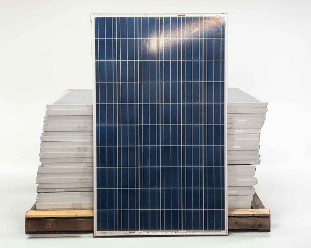 Phono Solar PS250P-20/U 250W solar panel front face showing blue polycrystalline cell grid with pallet of panels in background