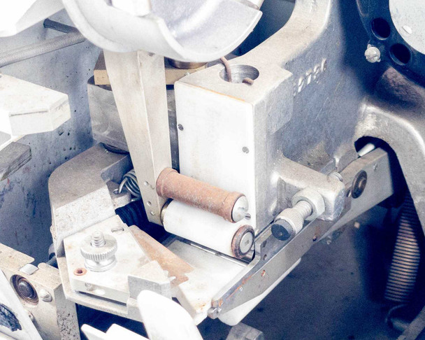Hollywood Film Company 2816 interior detail – transport roller assembly with visible surface rust on roller shaft and surrounding metalwork