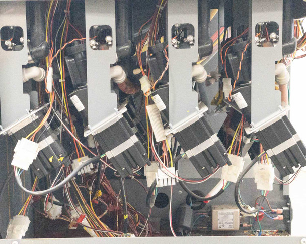 Interior view of Accutinter 1600HS pump drive section showing row of stepper motors with multi-color wiring harnesses