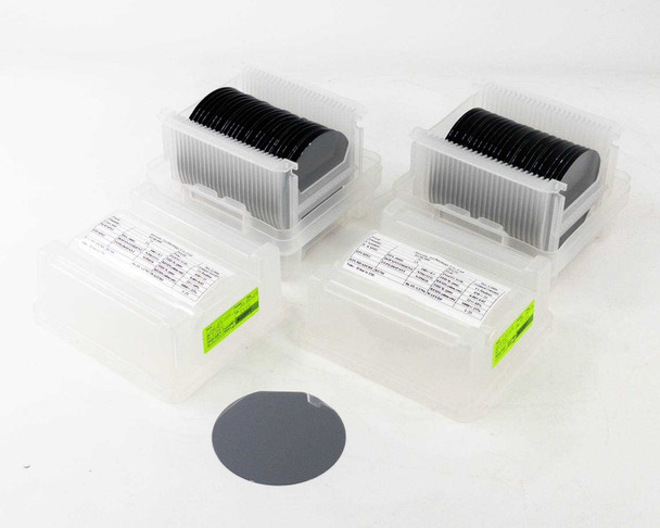 Atecom 100mm polished silicon wafers – two cassettes of 25 wafers each in clear plastic carriers with one loose wafer in foreground