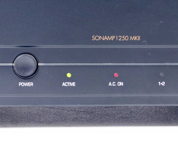 Sonance SONAMP 1250 MKII front panel close-up — Power button with Active (yellow) and A.C. On (red) LEDs illuminated, channels 1-2 label visible