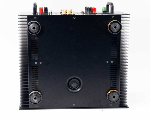 Sonance SONAMP 1250 MKII bottom view showing chassis base with four rubber isolation feet and partial view of rear speaker binding posts