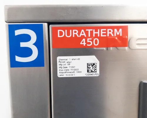Close-up of Duratherm 450 heat transfer fluid label and chemical tracking sticker on Lneya SUNDI-255 chiller cabinet