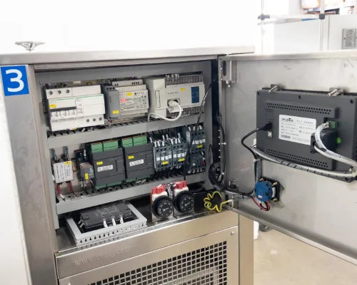 Interior electrical cabinet of Lneya SUNDI-255 showing circuit breakers, contactors, relays, DIN-rail mounted power supply, LNEYA controller module, and wiring harness