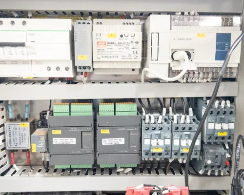 Interior lower electrical panel of Lneya SUNDI-255 showing Mean Well DIN-rail power supply, LNEYA PLC/controller, and multiple relay/contactor assemblies