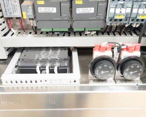 Interior lower panel detail showing solid-state relay block, two Pixsys temperature controller modules, and wiring connections