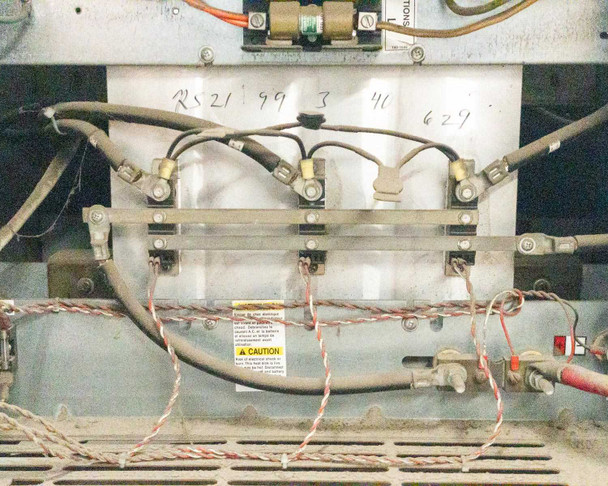 Interior view of SCR assembly and transformer wiring with caution label visible