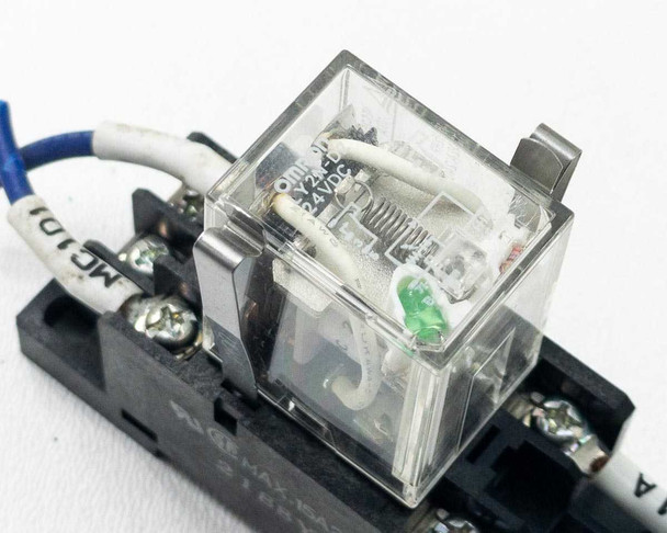 Close-up of Omron LY2N-D2 relay in socket showing label: LY2N-D2, 10A 24VDC, and green LED indicator
