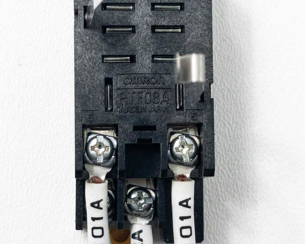 Underside of Omron PTF08A relay socket base showing Omron branding, Made in Japan marking, and screw terminals