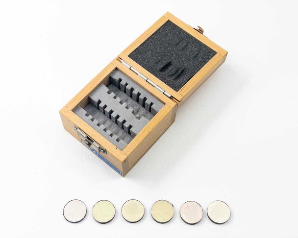 CVI Laser FS10-NiR-1.00 NIR interference filter set in open wood storage case with all six 1-inch filters laid out in front