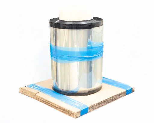 3M UBF 510-F ETFE ultra barrier solar film roll standing upright on cardboard pallet, secured with blue tape, showing clear multilayer film surface and black edge