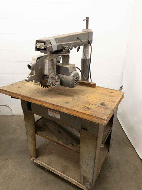 DeWalt 7790 radial arm saw with work table – right-side three-quarter view showing full machine on stand