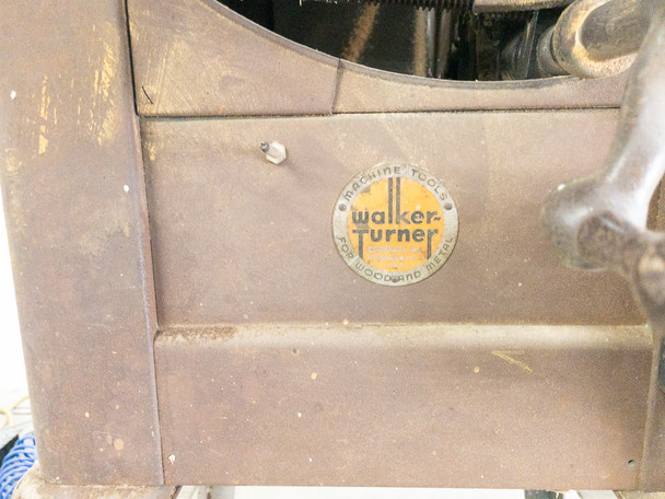 Walker-Turner Machine Tools nameplate badge close-up on cast iron saw body