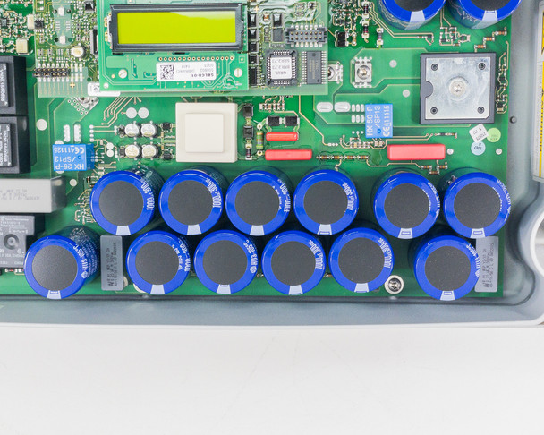 SMA SB3000US internal PCB — close-up of blue electrolytic capacitor bank on main circuit board