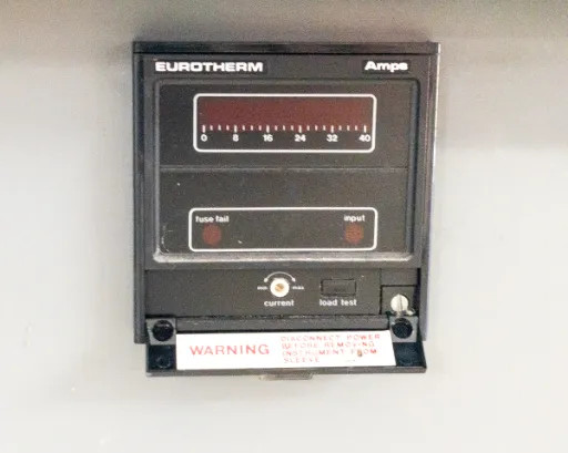 Close-up of Eurotherm Amps display panel with fuse fail and input indicators, current and load test buttons, and warning label