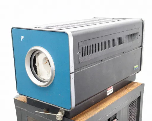 Lindberg 54454 Hevi-Duty Tube Furnace blue end-panel and black vented chassis, seated on controller cabinet – side angle view