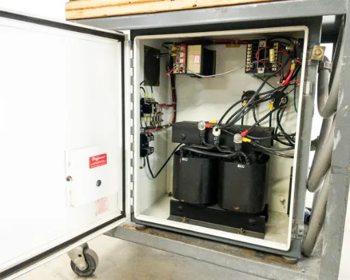 Interior of Lindberg 54454 controller cabinet with door open showing dual transformers, wiring, terminal blocks, and contactor