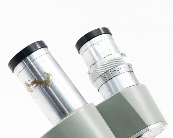 Close-up of left and right eyepiece tubes showing oxidation and surface spotting on left tube and diopter scale on right