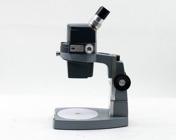 American Optical AO 569 Stereo Star Zoom Microscope right-side profile showing monocular eyepiece, zoom body, and 560-1 base