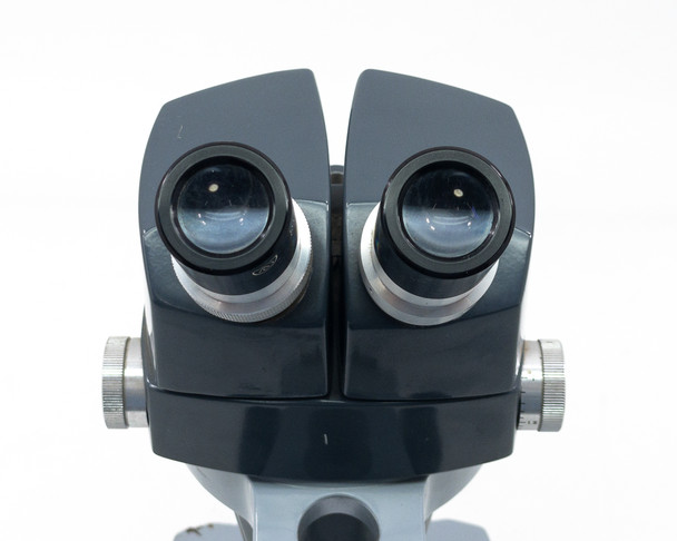 Top-down view of AO 569 binocular eyepiece pair showing clean objective lenses and interpupillary adjustment