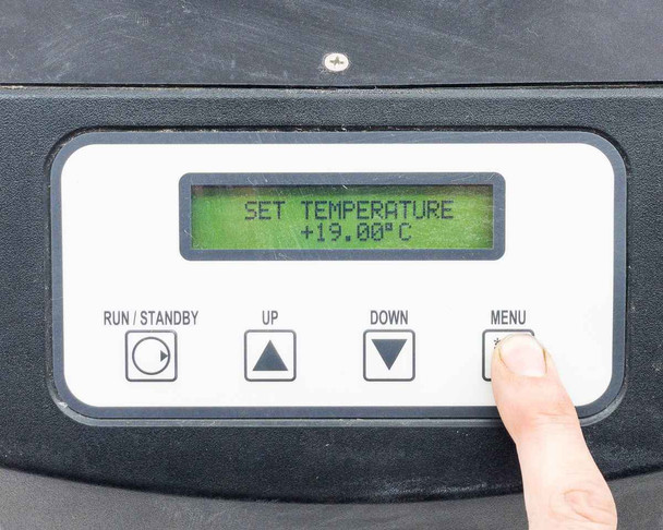 ThermoTek T255P — front panel LCD display powered on showing SET TEMPERATURE +19.00°C with finger pressing MENU button