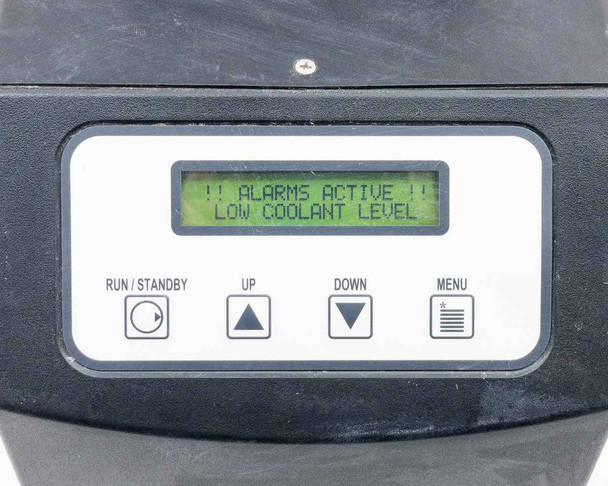ThermoTek T255P — front panel LCD display showing ALARMS ACTIVE LOW COOLANT LEVEL alarm (reservoir empty during photography)