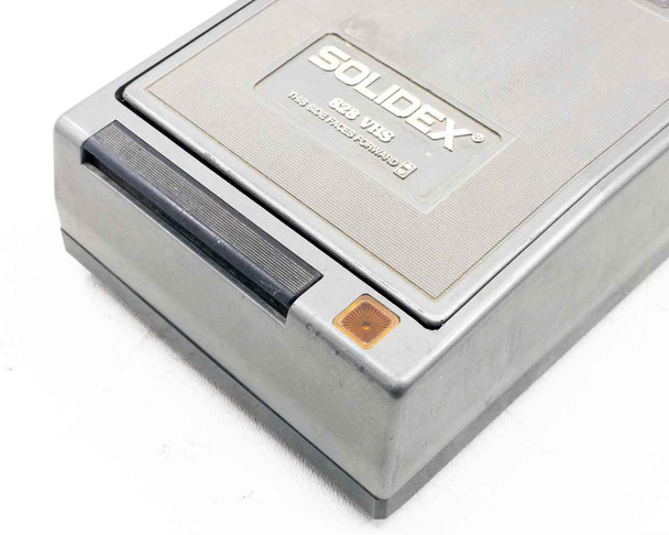 Solidex 828 VHS rewinder – close-up of front tape insertion slot and orange power indicator button with label