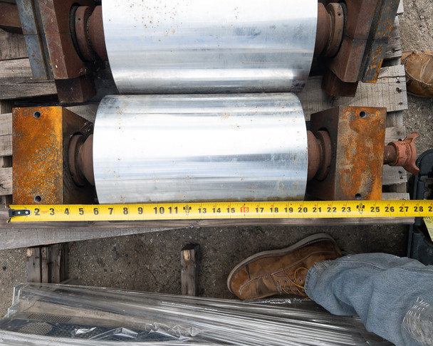 Top-down view of conveyor drum with tape measure showing overall drum length approximately 24 inches