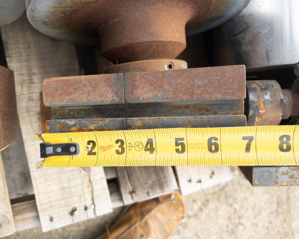 Side view of hydraulic brake mounting block with tape measure showing approximately 6-inch block depth