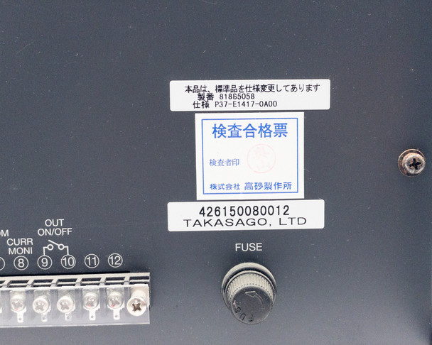 Takasago BWS 40-15 rear panel lower section showing inspection label, serial number barcode, fuse holder, and terminal block
