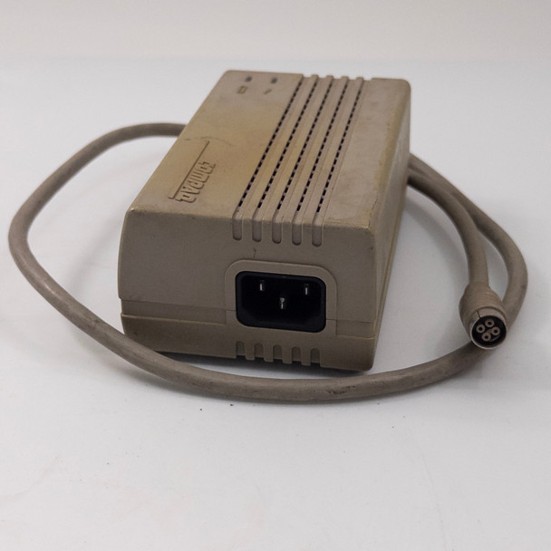 Compaq Series 2692 AC Adapter rear view showing IEC C14 three-prong AC inlet and Compaq logo with attached output cable