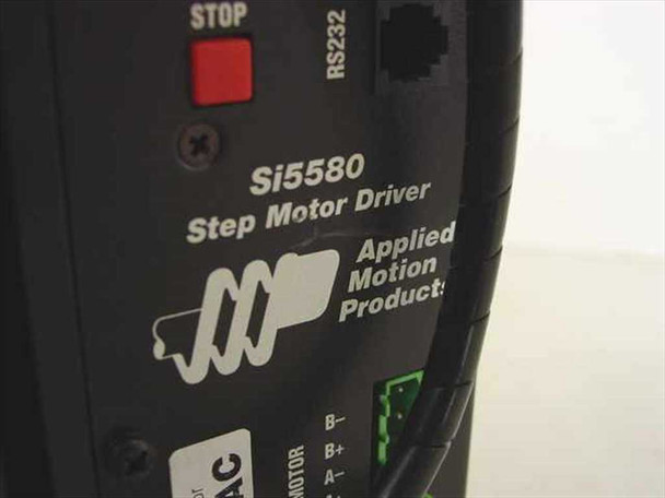 Applied Motion Products Si5580 Step Motor Driver closeup — RS232 port, Stop button, and motor terminal labels visible on side panel