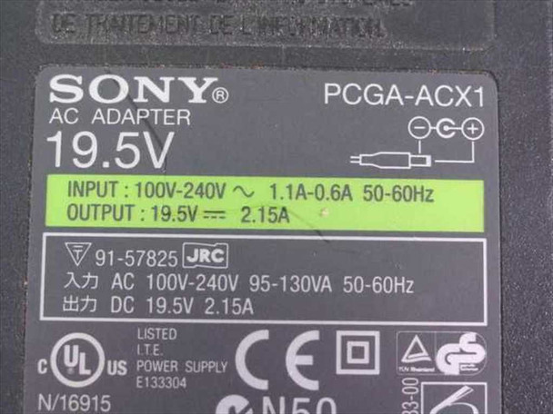 Sony PCGA-ACX1 AC adapter close-up of rating label showing 19.5V output, 2.15A, input 100-240V 50-60Hz, part number 91-57825, UL and CE marks