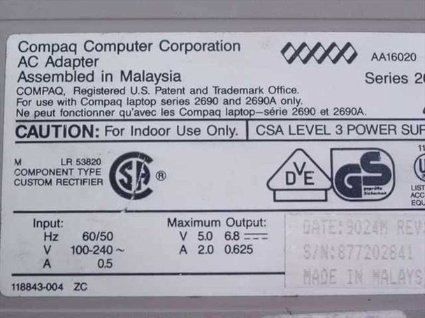 Compaq 118843-004 AC Adapter bottom label showing model number, input/output specs, CSA/VDE/GS certifications, and Made in Malaysia