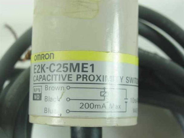Omron E2K-C25ME1 label closeup showing model number, NPN NO output wiring diagram, and 200mA max rating