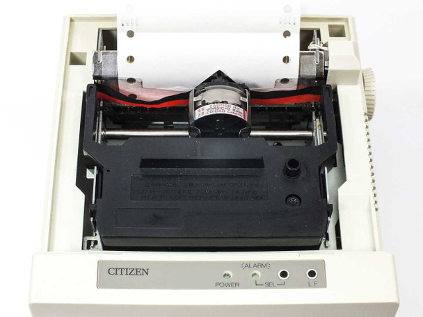 Citizen CBM iDP3530 interior view with cover open – dot matrix print head, ribbon cartridge, and platen visible; POWER and ALARM indicator LEDs on front panel