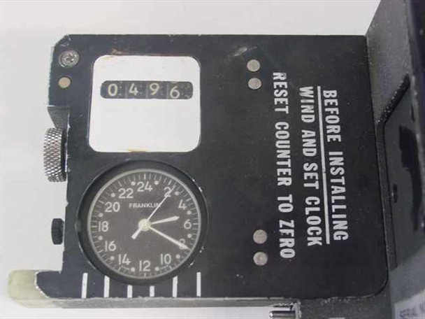 GE 7321-400-3 Military Film Magazine – end panel close-up showing Franklin 24-hour clock reading and frame counter at 0496