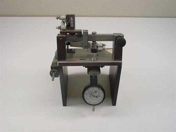 SMC pneumatic tolerance checking fixture front view showing analog dial indicator gauge mounted below linear slide assembly