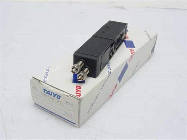 Taiyo USR540-MXF hydraulic pneumatic block manifold in original Taiyo box — front angled view showing two stainless port fittings