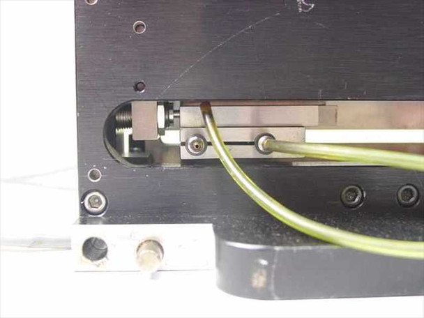 Stelron DS3-6-C – closeup of linear carriage mechanism underside showing rail, carriage block, yellow-green pneumatic tubing and fittings