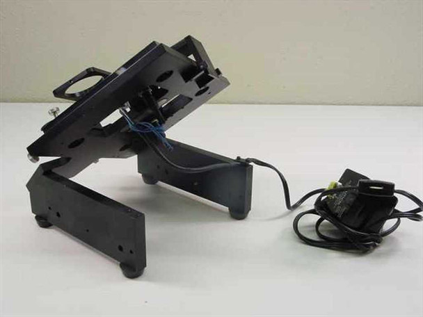 Custom optical stage assembly shown folded/tilted — side profile view with external AC adapter visible
