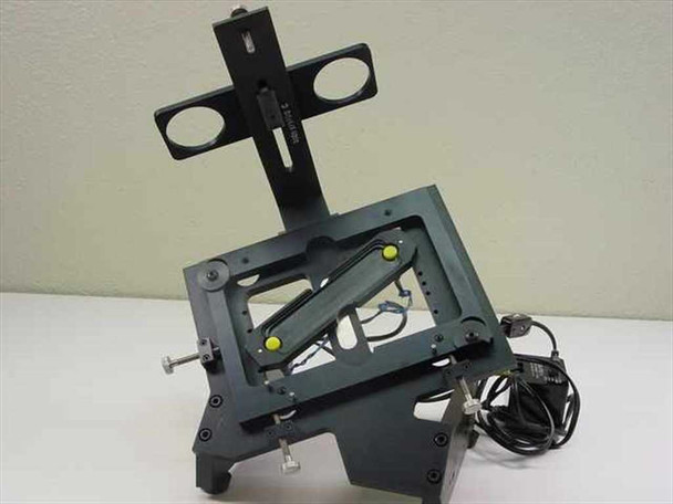 Custom optical stage assembly tilted upright showing vertical optical mount bracket and angled multi-axis frame with inline power cord