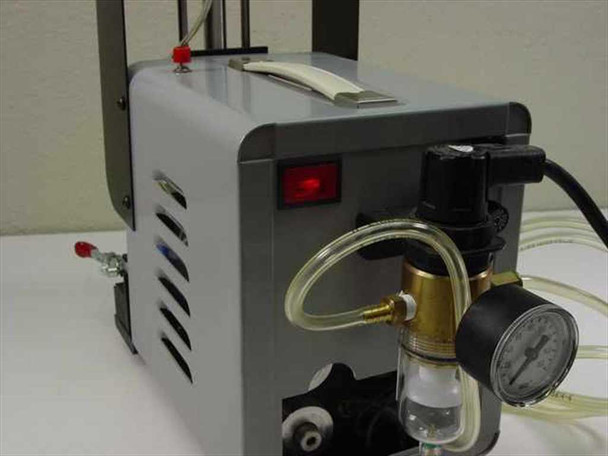 Ultramation OA-4 Pneumatic Linear Thruster — rear-right view of compressor pump showing red power indicator lamp, on/off switch, vented housing, regulator, and tubing connections