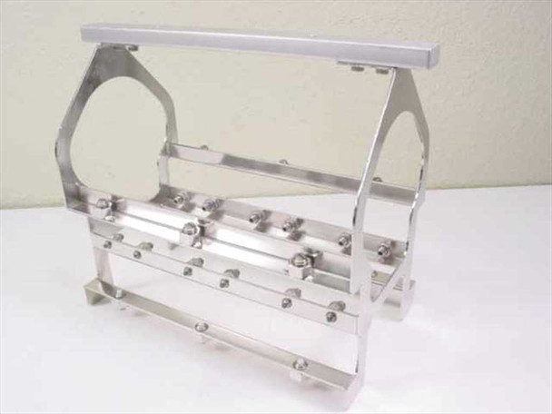 Applied Magnetics NL Block Carrier – front three-quarter view showing polished aluminum frame, cylindrical spool cradle, and rows of adjustment bolts