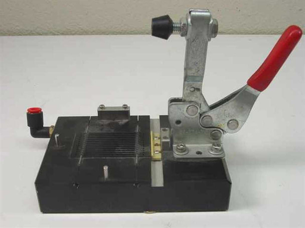 Pneumatic toggle clamp fixture assembly – front-angle view showing toggle clamp arm with rubber contact tip, black base block, and slotted top surface