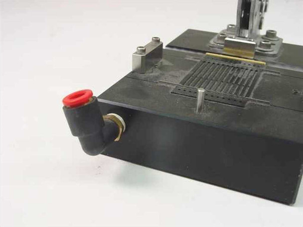 Pneumatic toggle clamp fixture assembly – close-up of push-in elbow pneumatic fitting with red ring on left side of base
