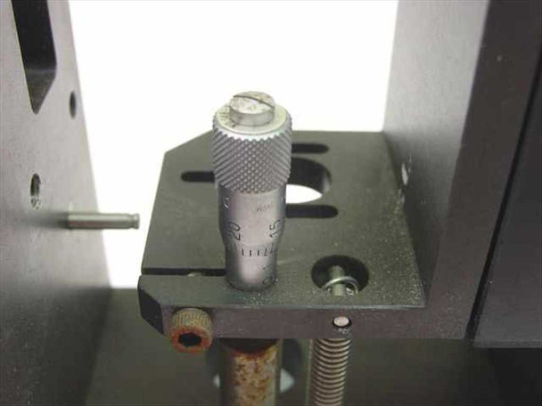 Daedal linear slide assembly – close-up of knurled micrometer adjuster with graduated scale visible, mounted between anodized aluminum uprights